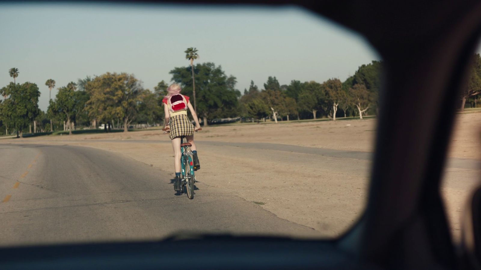 a person riding a bike down a street