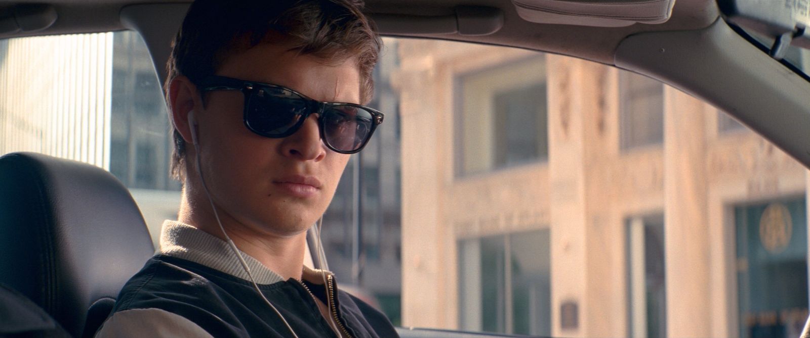 a man wearing sunglasses sitting in a car