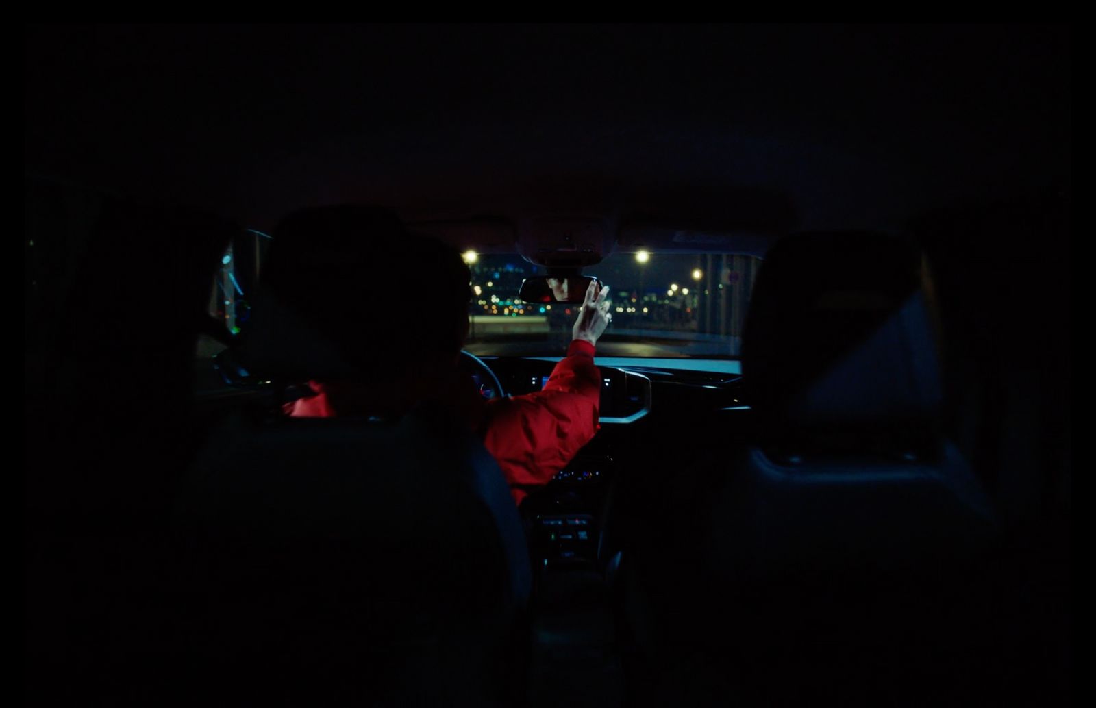 a man driving a car in the dark