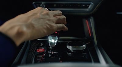 a man is adjusting the gear in a car