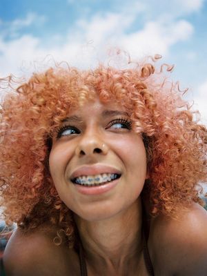 a woman with a toothbrush in her mouth