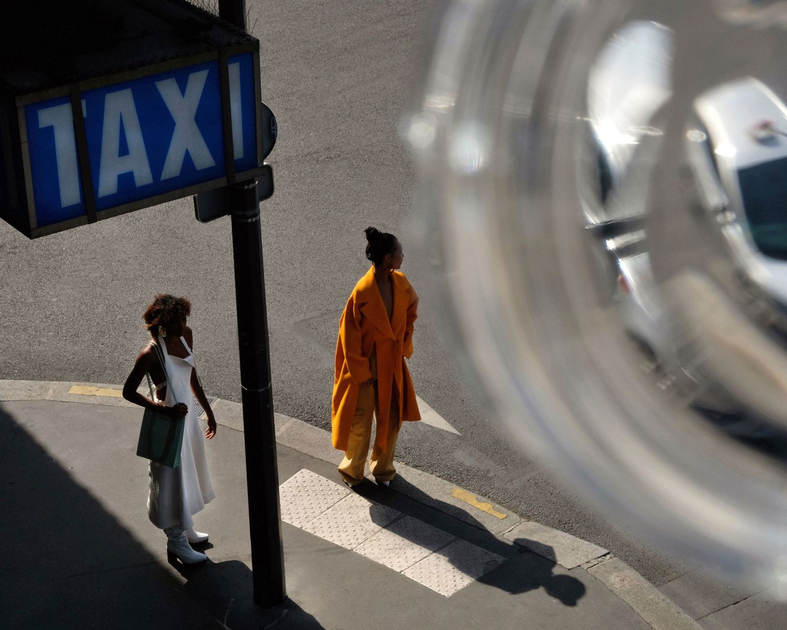 a couple of people that are walking down a street