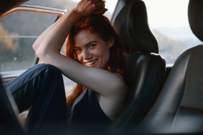 a woman sitting in the back seat of a car