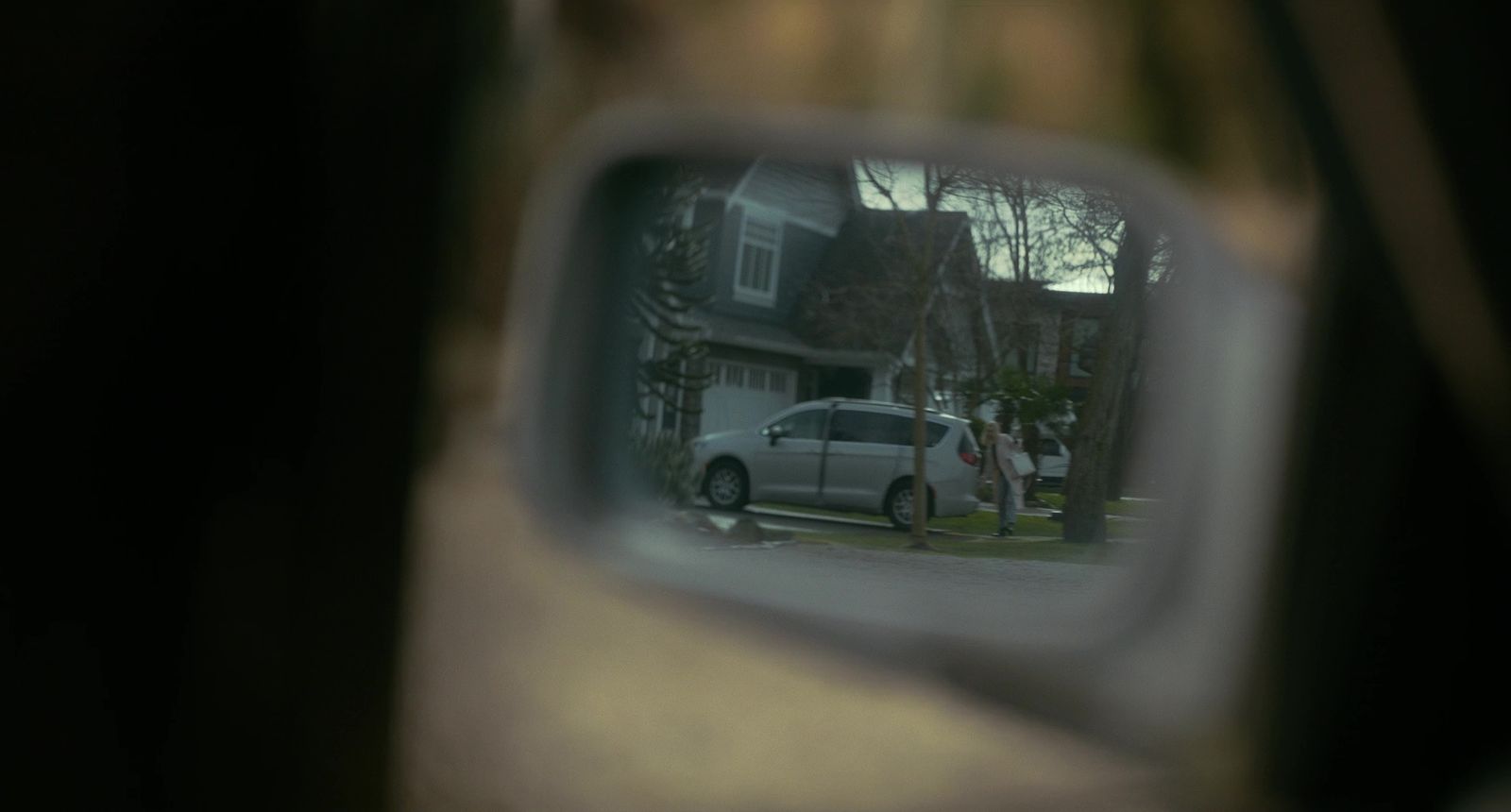 a car is seen in the side view mirror