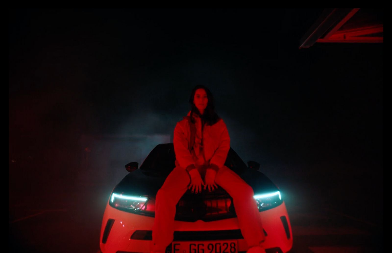 a woman sitting on the hood of a car