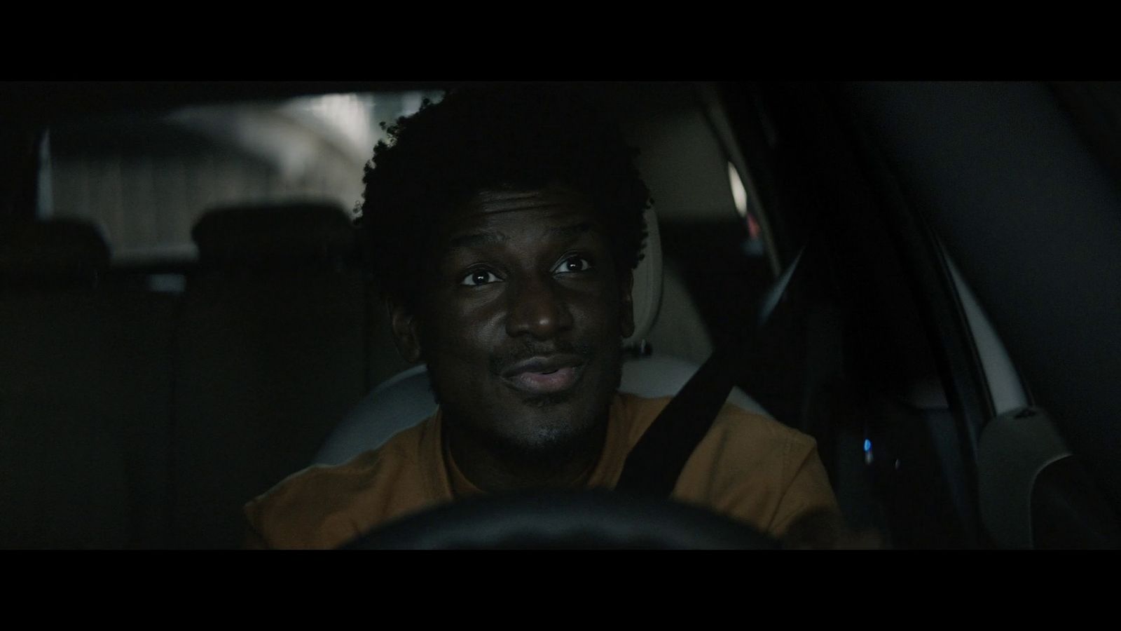 a man sitting in a car looking at the camera