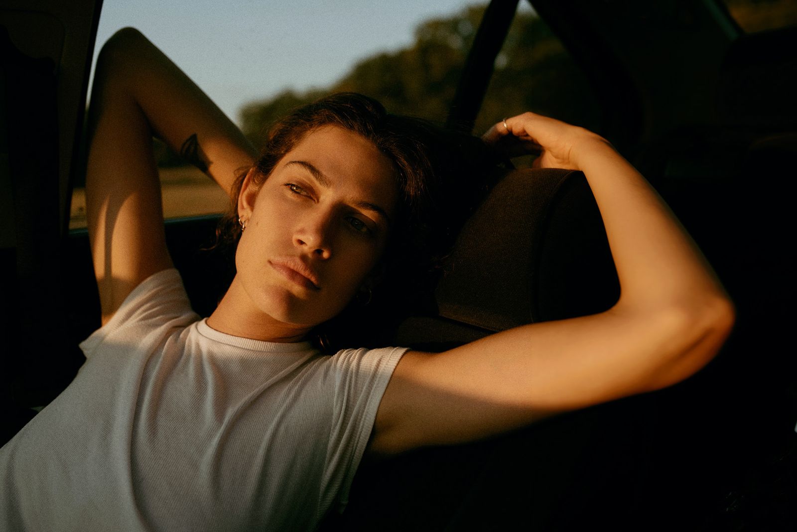 a young man sitting in the back of a car