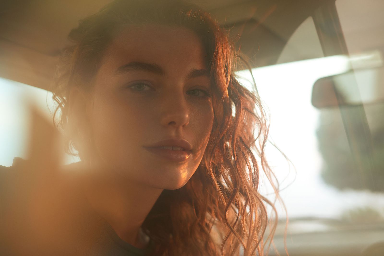 a woman sitting in the back seat of a car