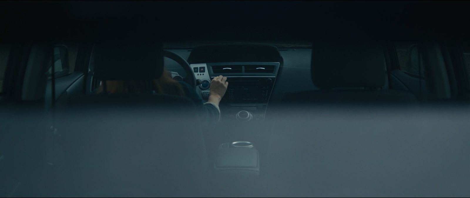 a person driving a car in the dark