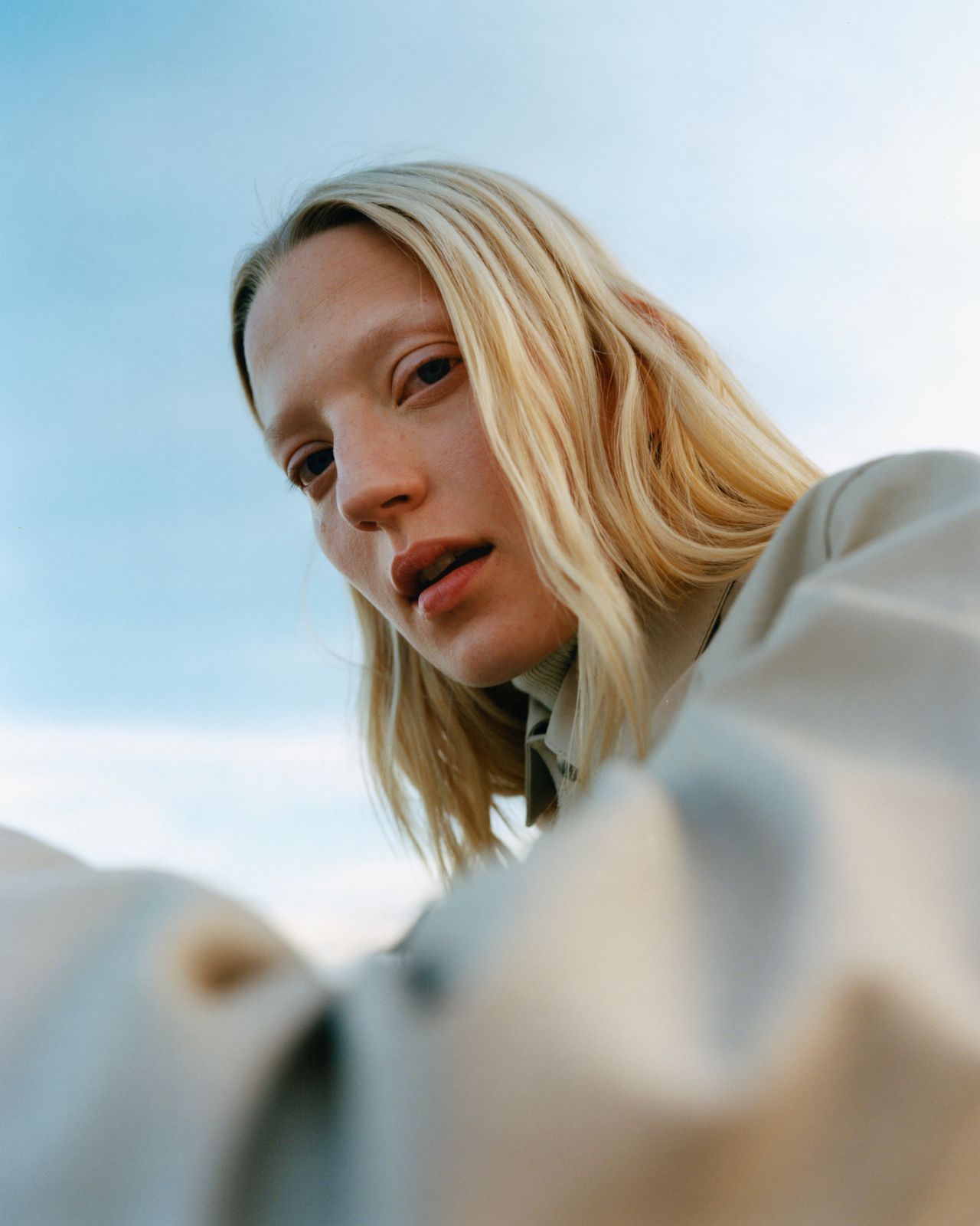 a woman with blonde hair wearing a white shirt