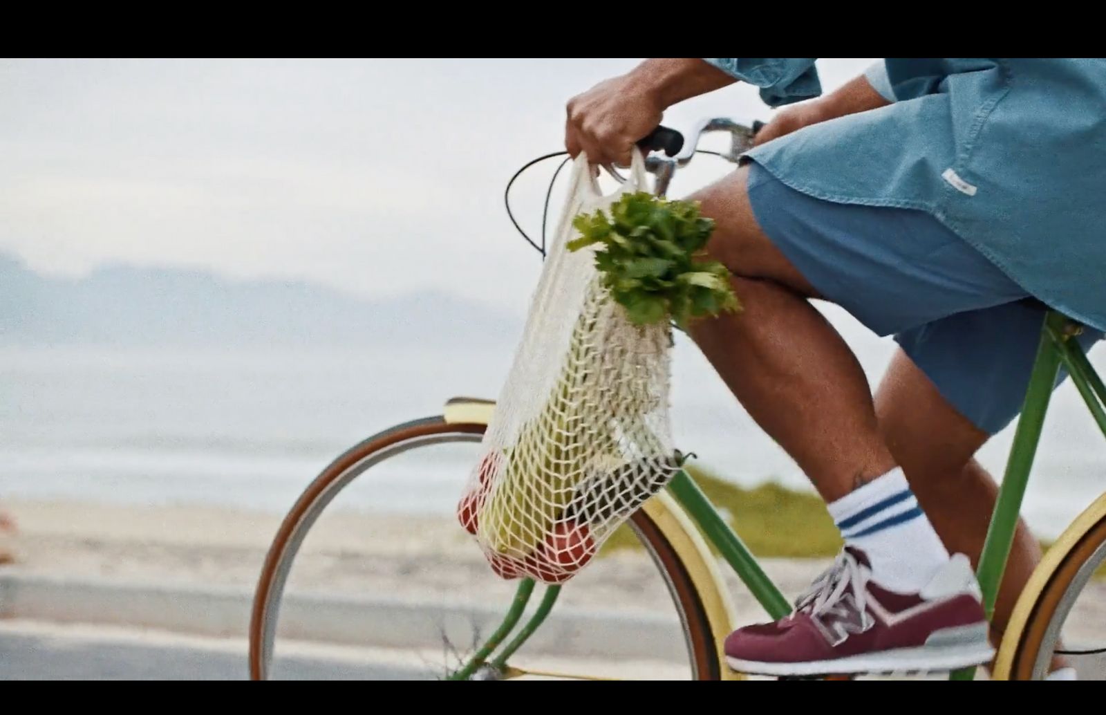 a man riding a bike with a net on the back of it