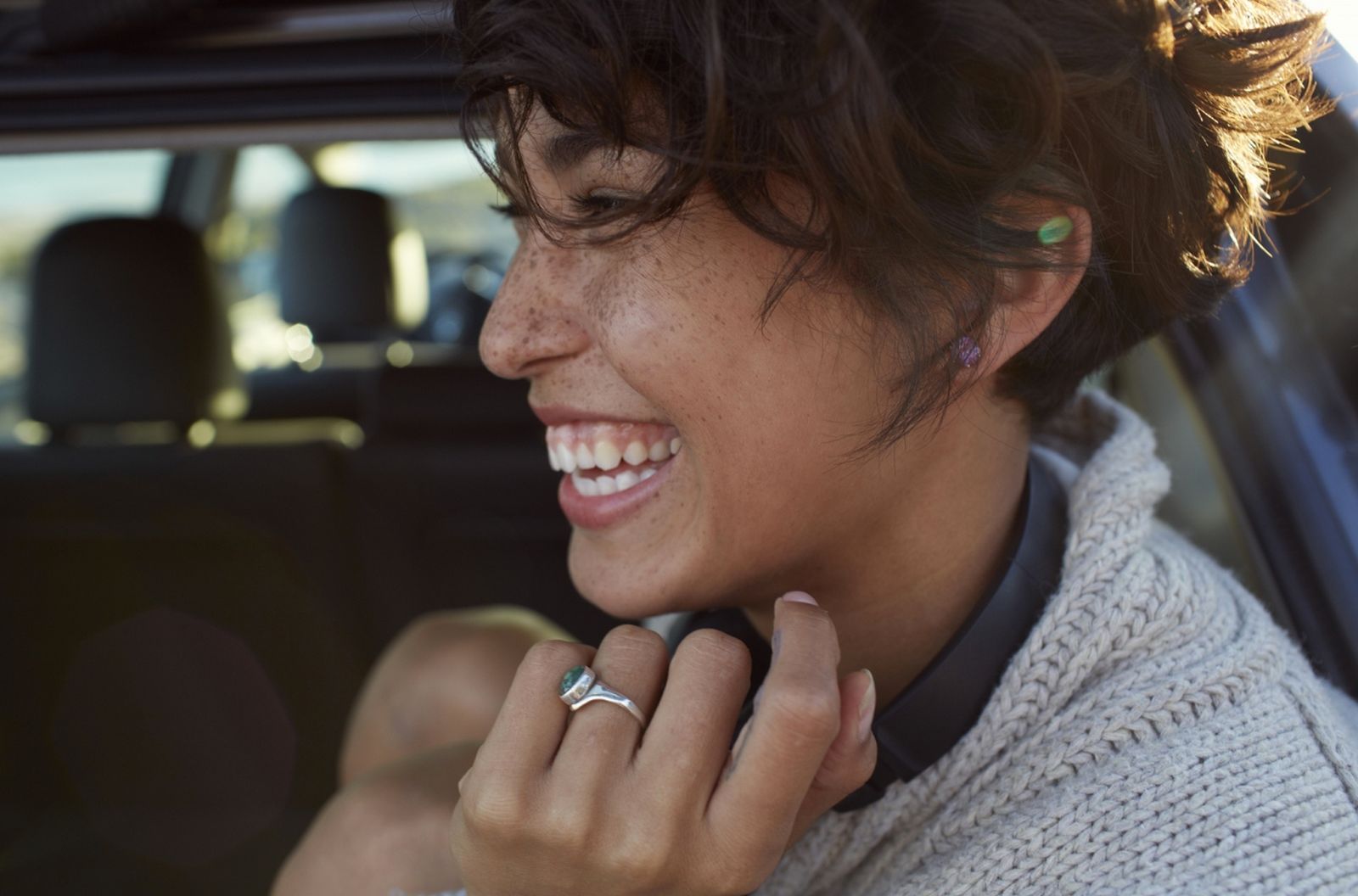 a woman smiling while talking on a cell phone