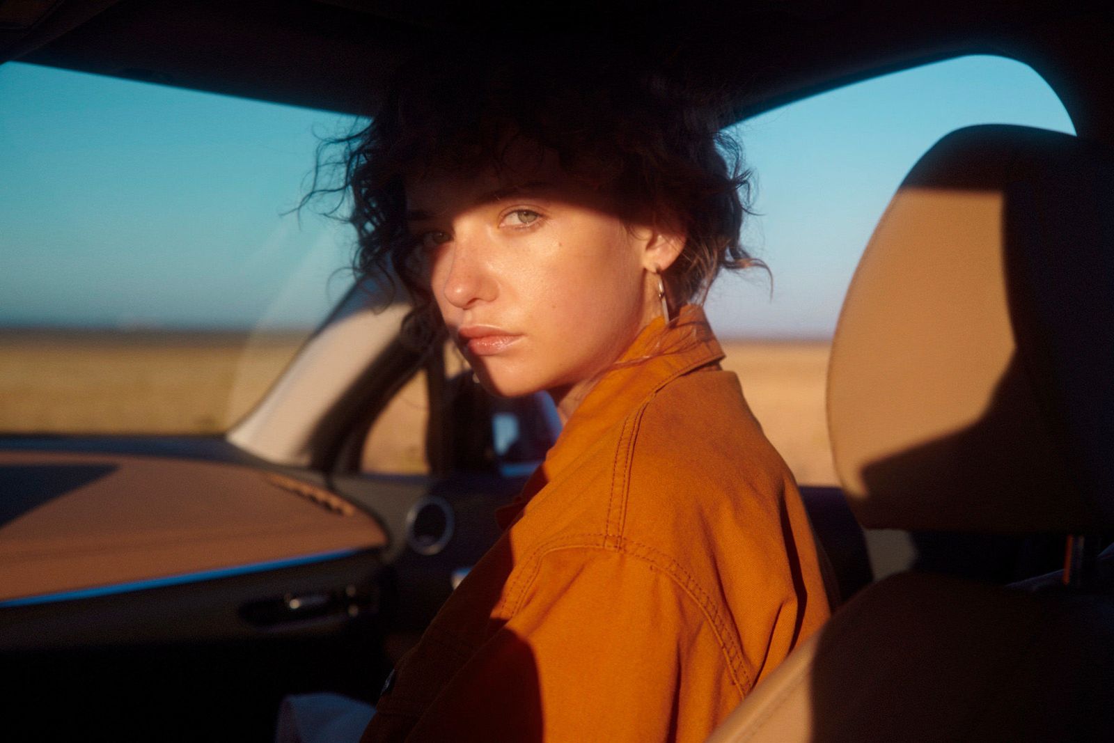 a woman sitting in the passenger seat of a car