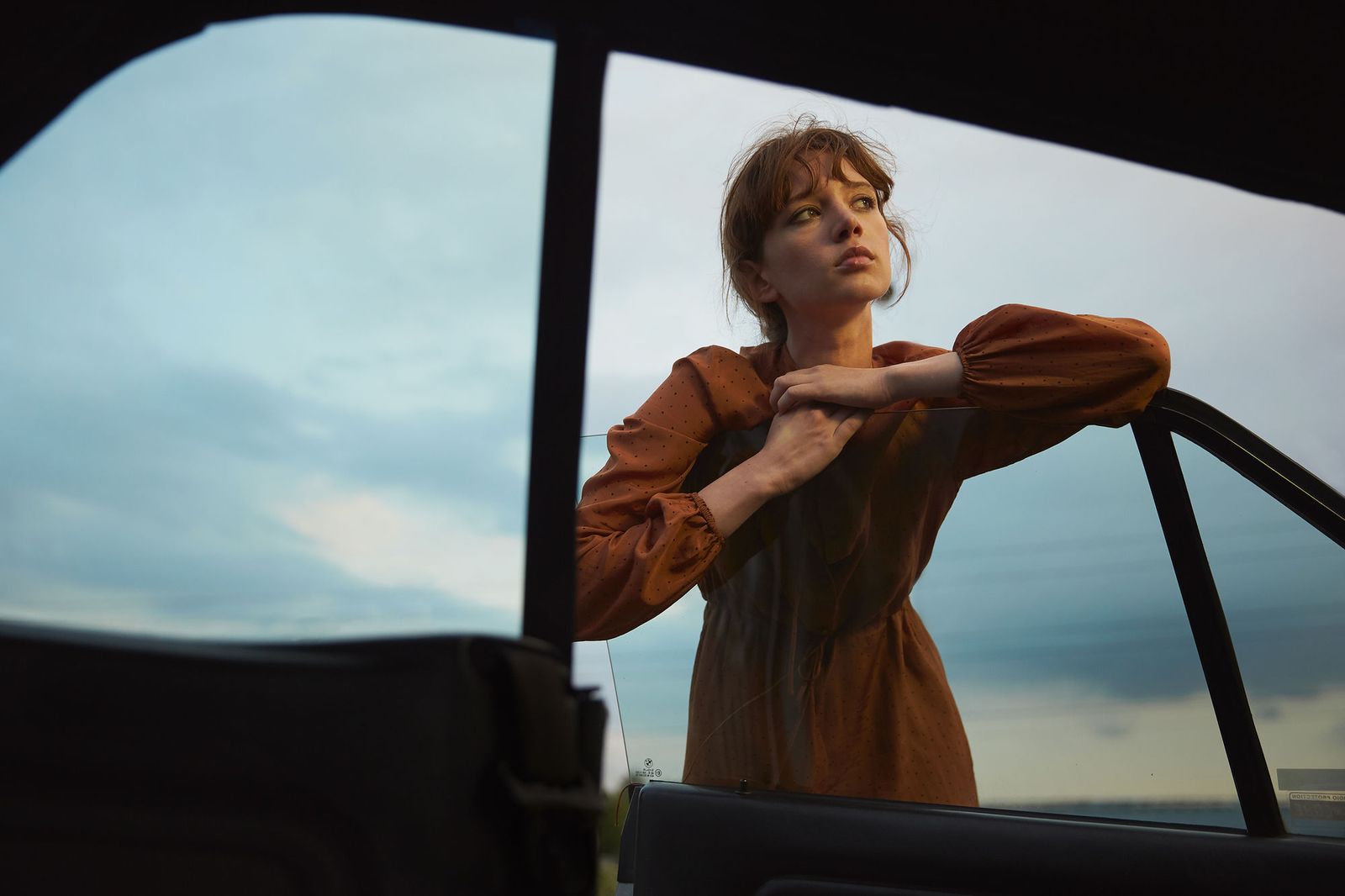 a woman leaning out of a car window