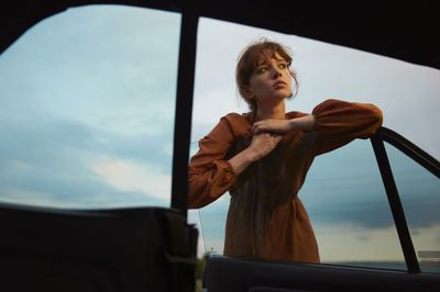 a woman leaning out of a car window