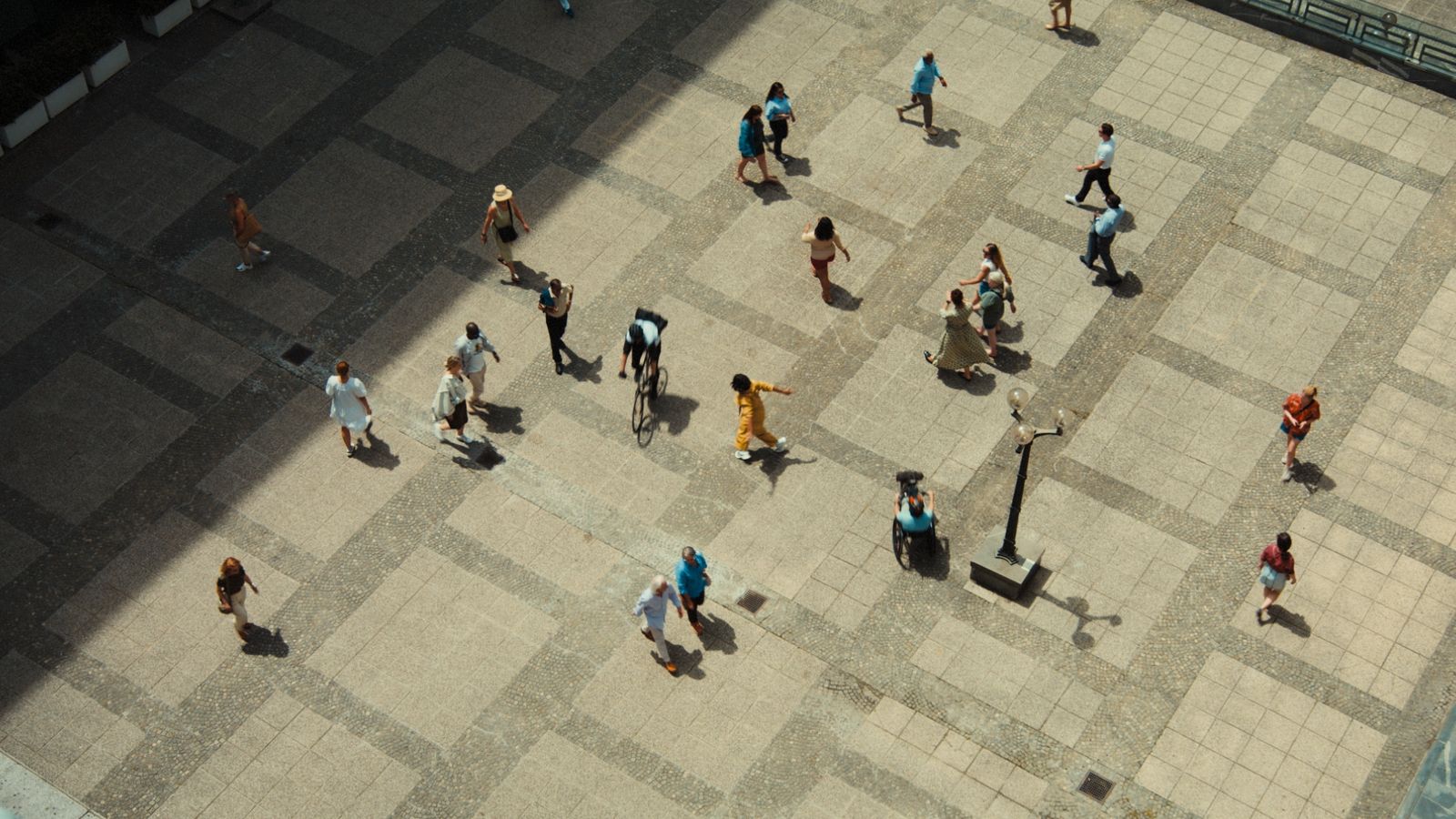 a group of people walking down a sidewalk