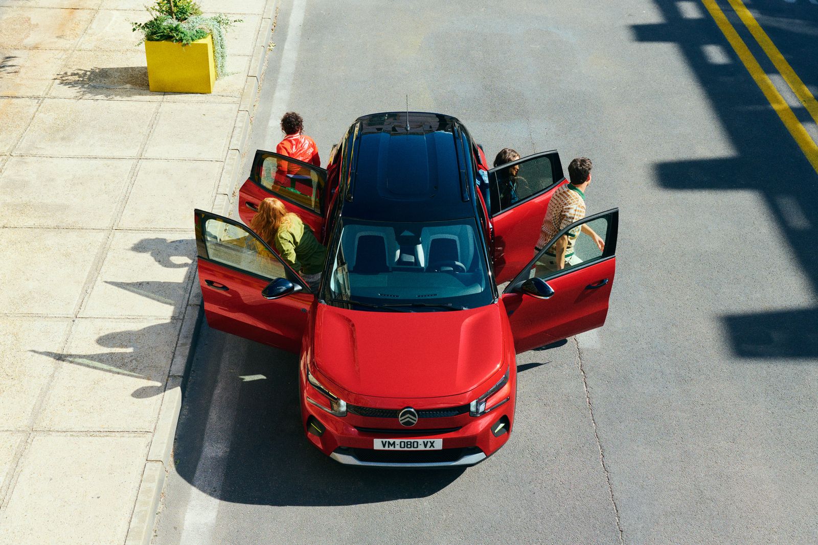 a red car is parked on the side of the road