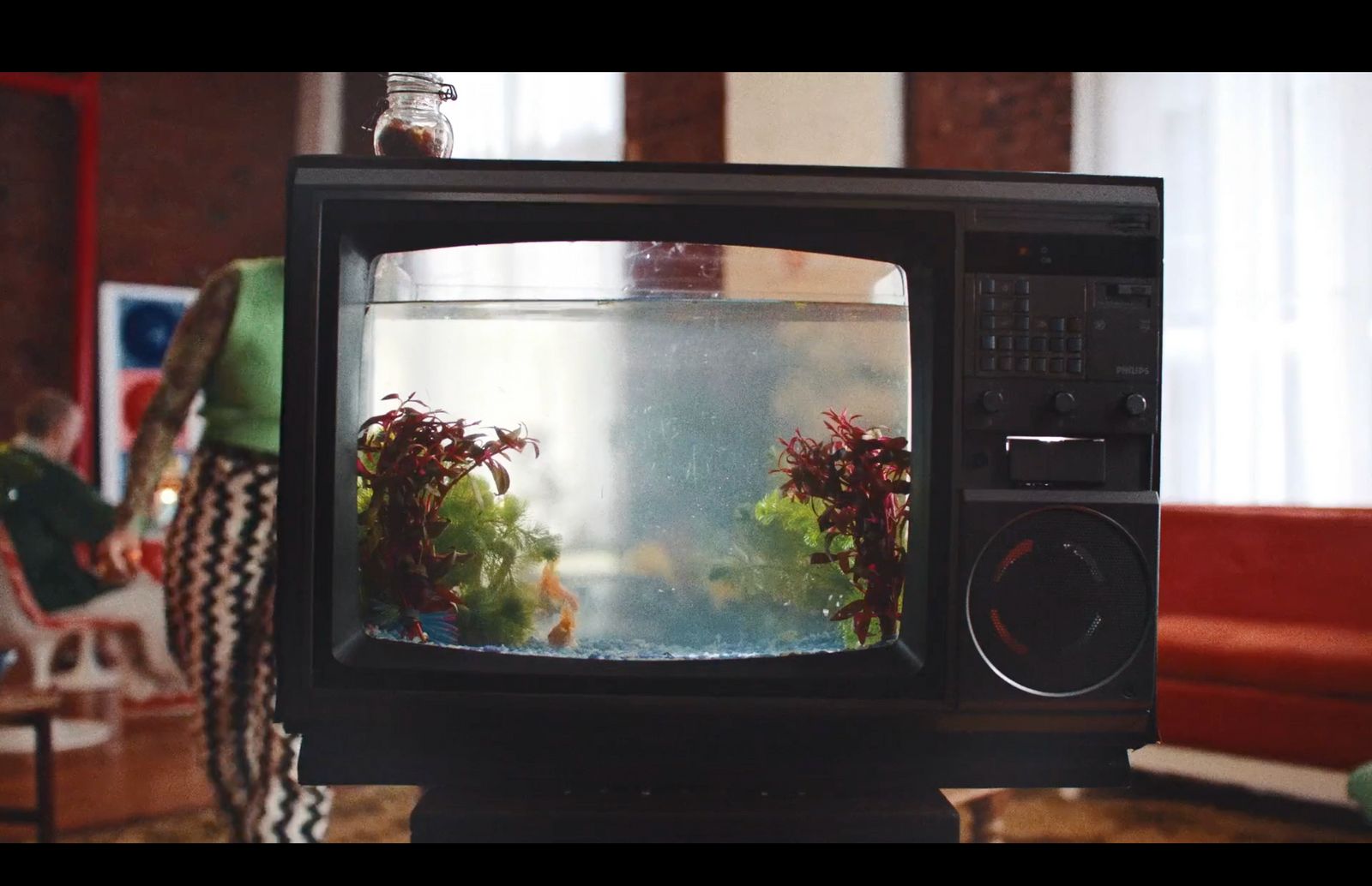 a television with a fish tank on top of it