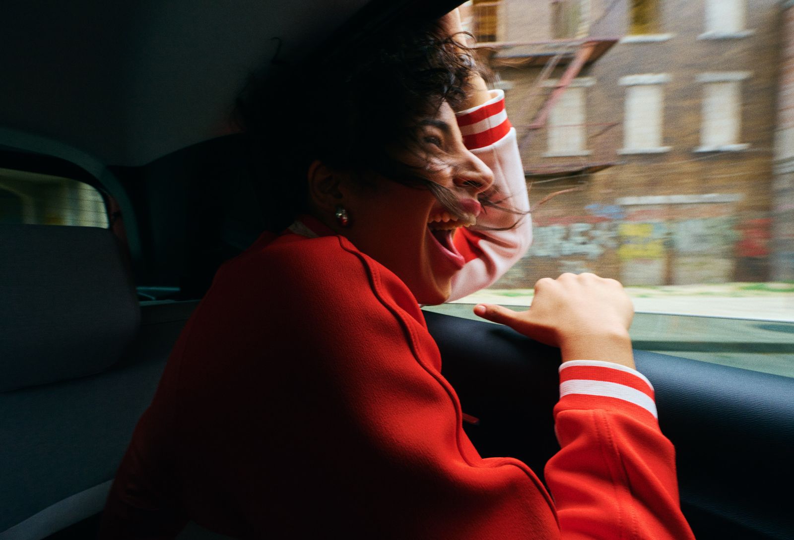 a woman sitting in a car with her mouth open