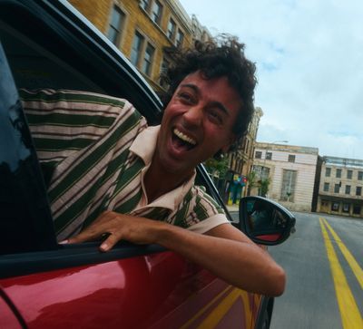 a man sticking his head out of a car window