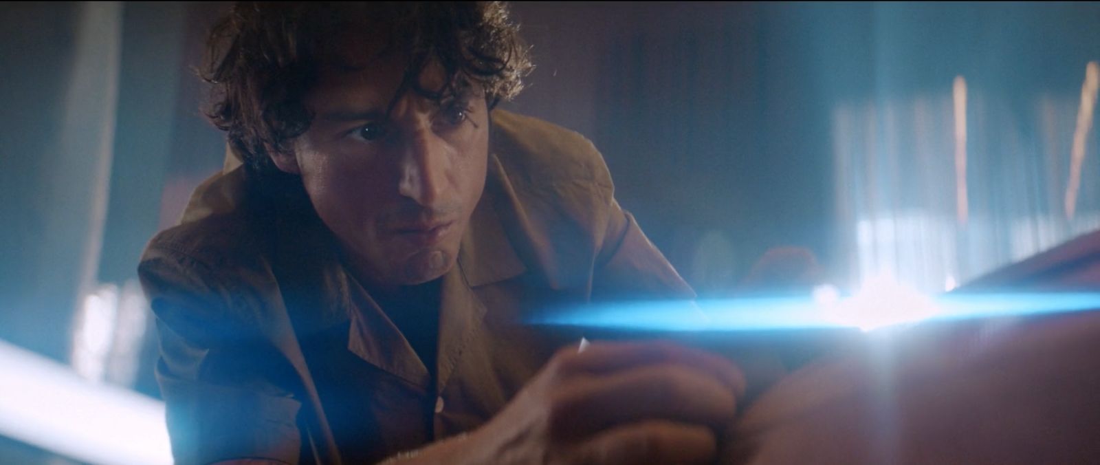 a man holding a light saber in his hand