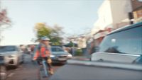 a blurry photo of a man riding a bike down a street