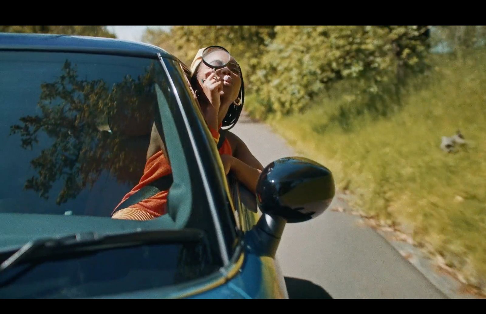 a woman talking on a cell phone while driving a car