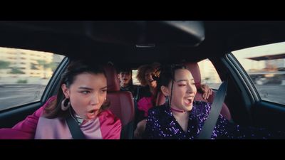 a group of women riding in the back of a car