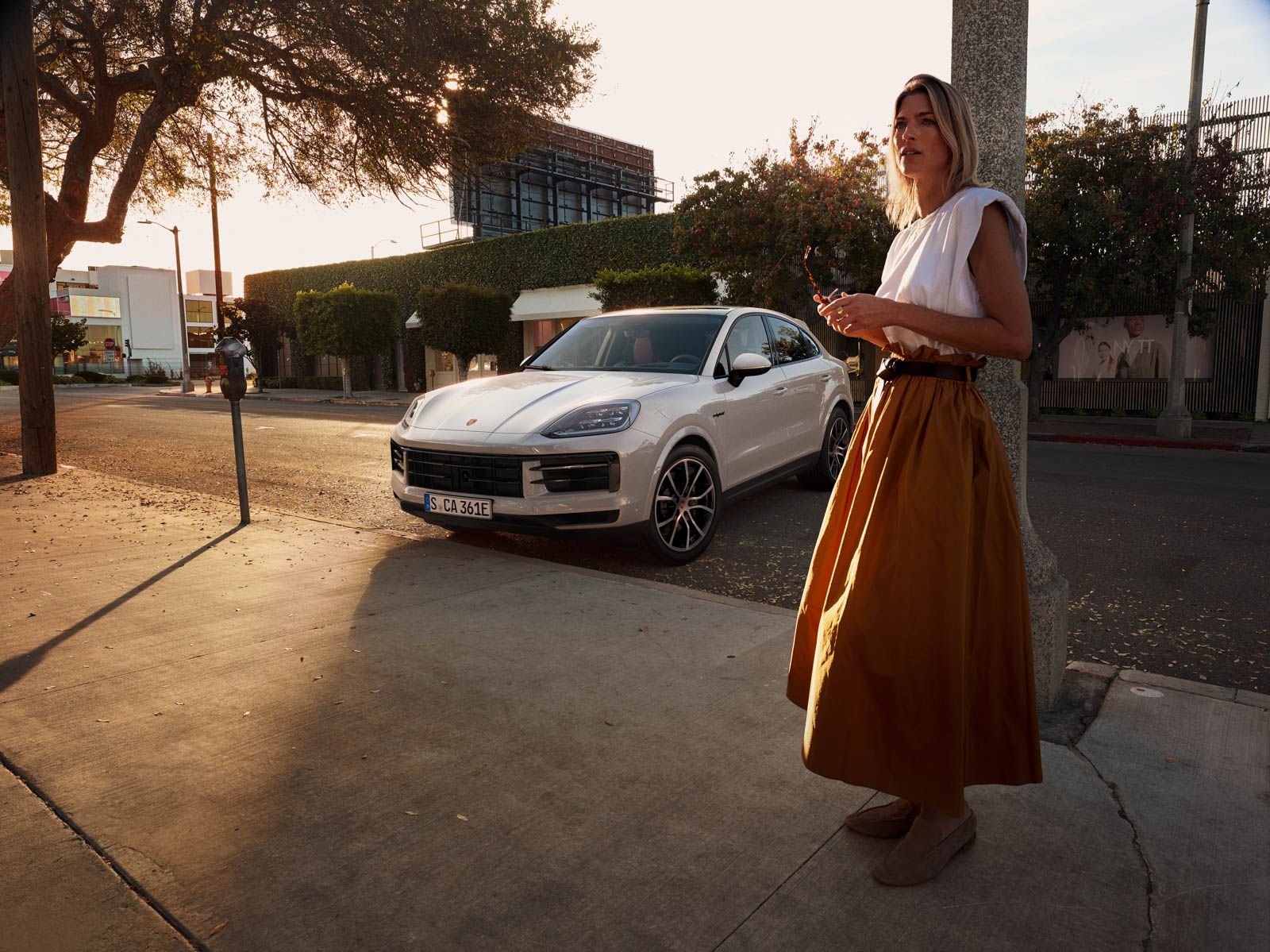 a woman standing next to a white car