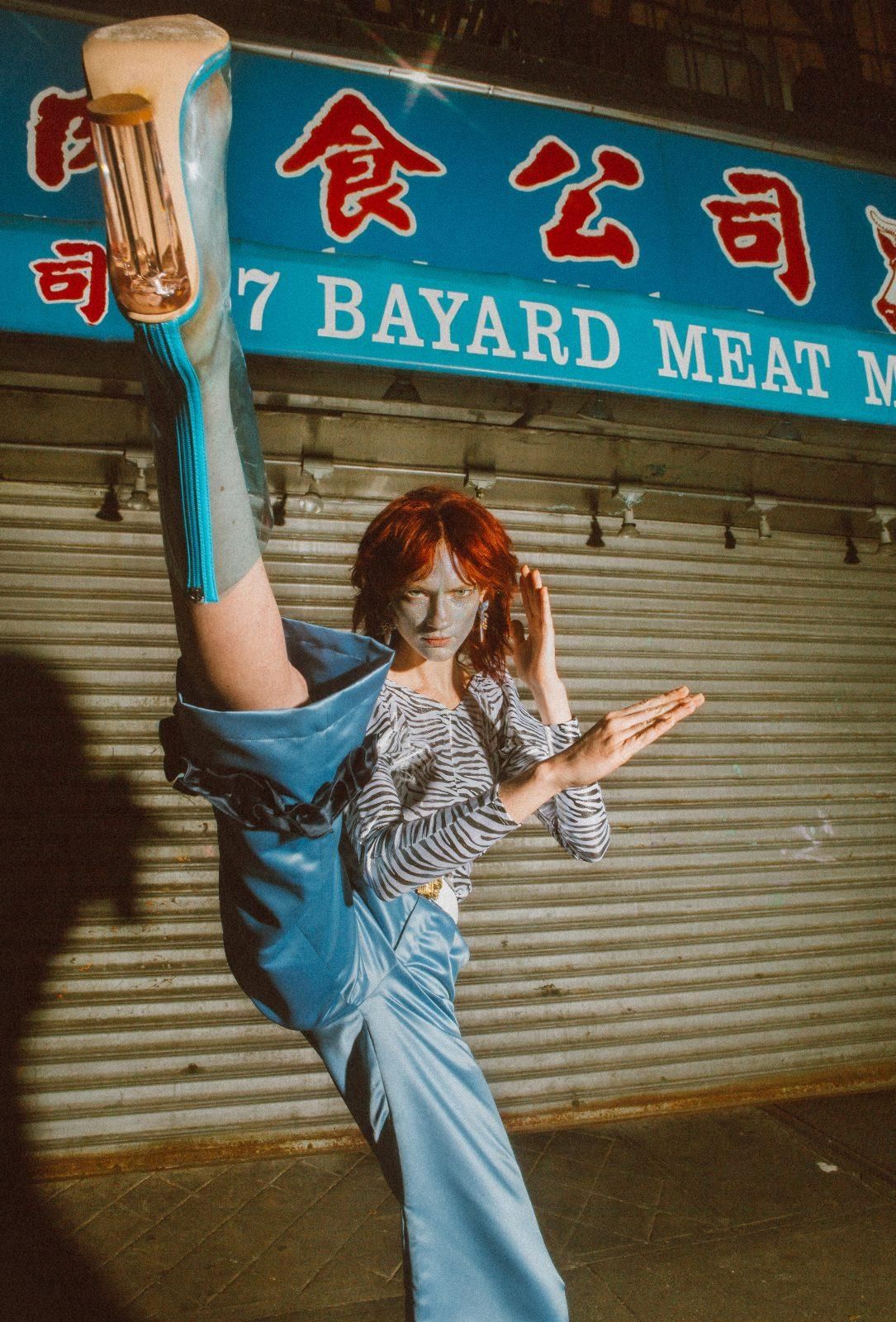 a woman is doing a trick on a skateboard