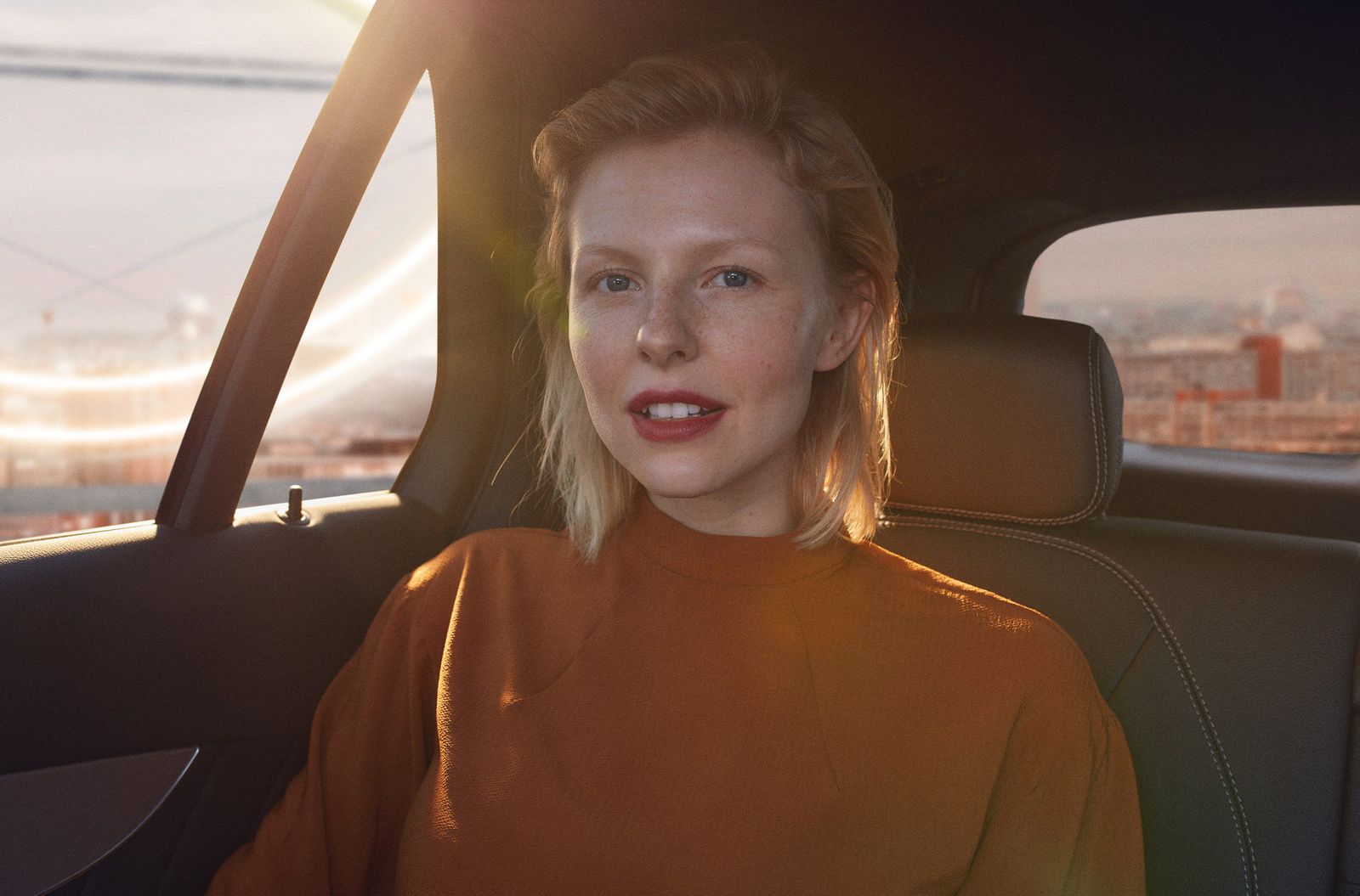 a woman sitting in the back seat of a car