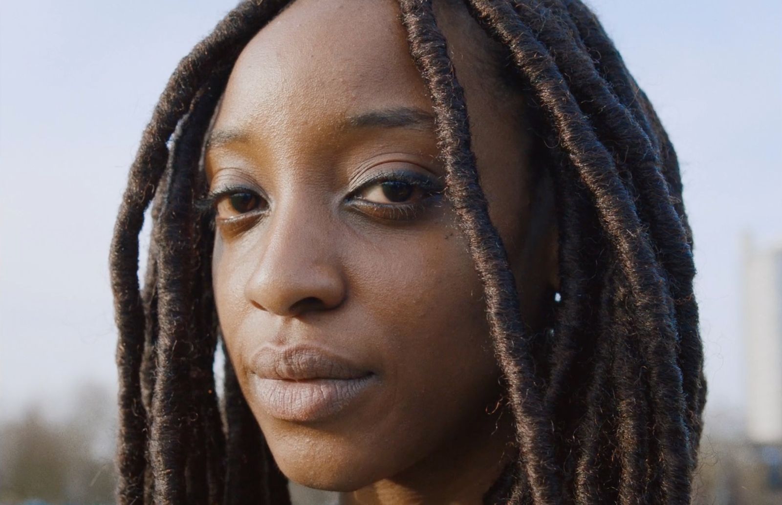 a close up of a person with dreadlocks