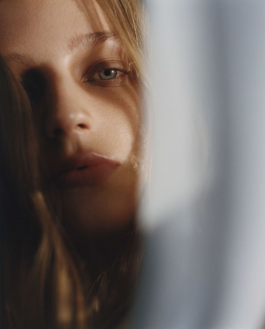 a close up of a woman's face with a blurry background