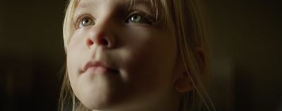 a close up of a child's face with a blurry background