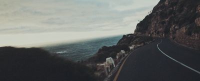 a view of a road next to the ocean