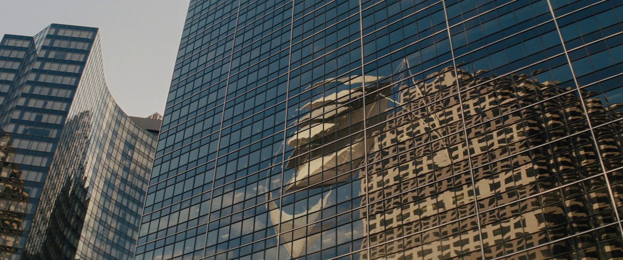 the reflection of a building in the windows of another building