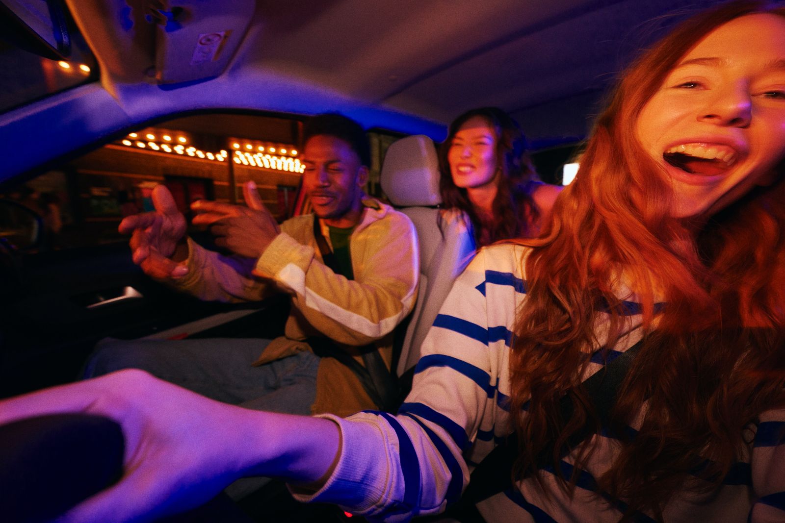 a group of people riding in a car at night