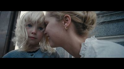 a woman and a young girl looking at each other