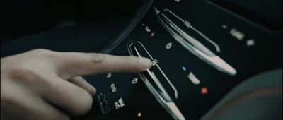 a person pressing buttons on a car dashboard