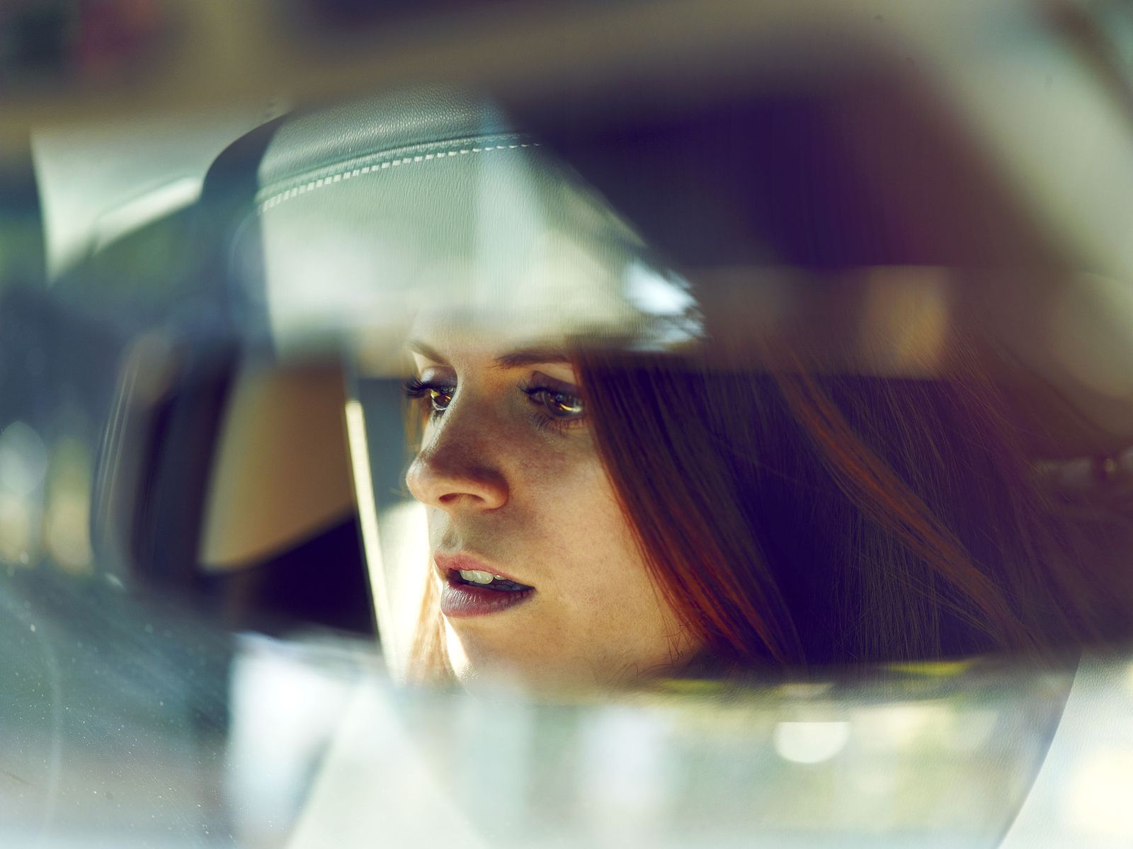 a woman in a car looking out the window