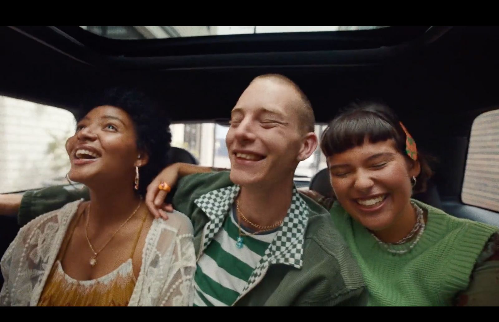 a group of people sitting in the back of a car