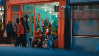 a group of people standing outside of a store