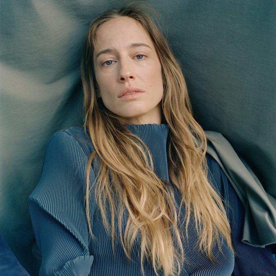 a woman with long hair sitting in a chair