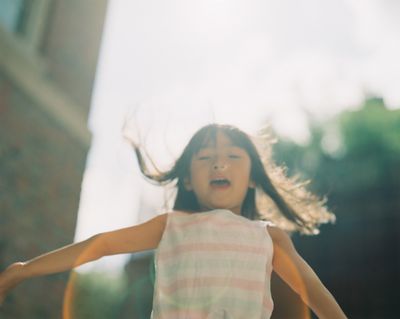 a little girl that is standing in the air