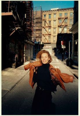 a woman is walking down a city street