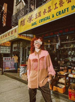 a woman standing in front of a craft store