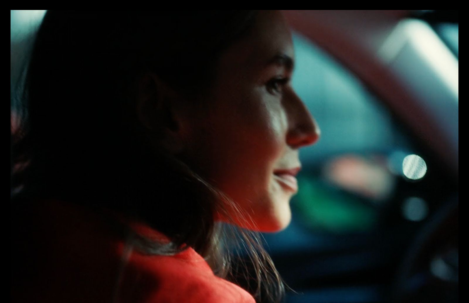 a woman sitting in a car with her head up