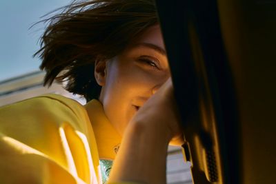 a woman is looking out the window of a car