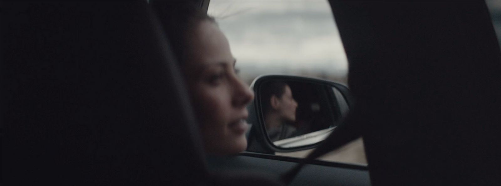 a man in a car looking out the window