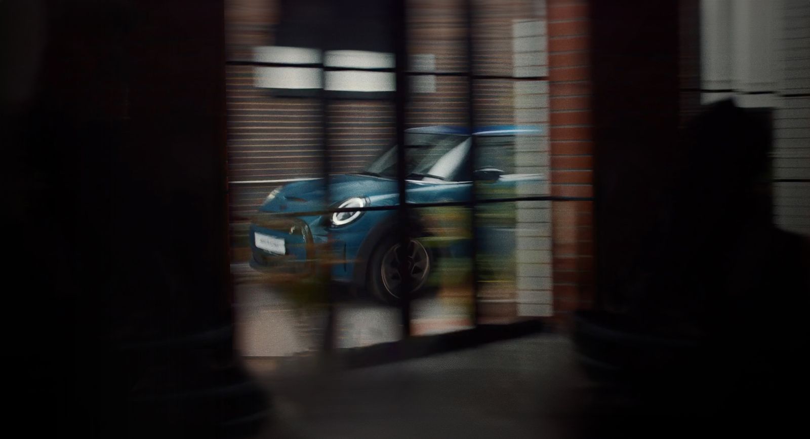 a blue car is seen through a window